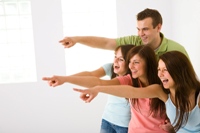 Four people pointing and laughing, demonstrating mocking scornful cattiness